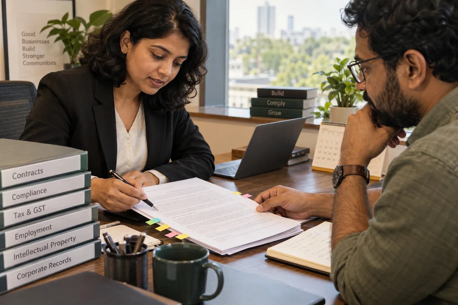 An adviser and business owner review a contract using notes and removable page tabs.